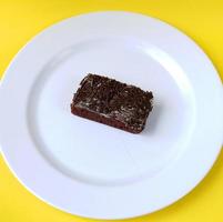 Sponge cake on white plate isolated photo
