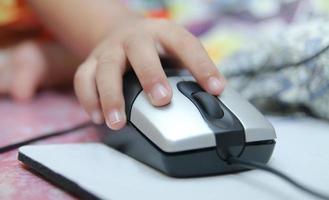 Child learns online and plays game on the computer at home. photo