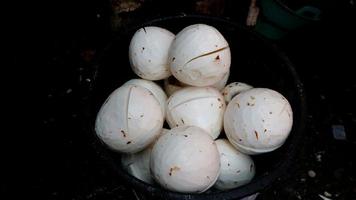 Several peeled coconuts were in traditional market photo
