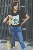 rock band cool girl portrait holding her bass guitar photo