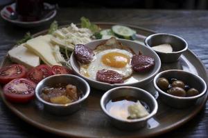 Turkish breakfast egg with sausage and more photo