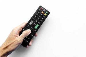 Man holding remote control on white background photo