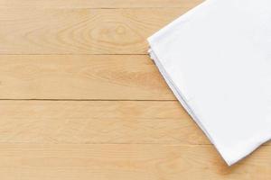 Top view empty white fabric on wooden table with copy space photo