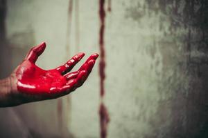 Close up of bloody hands in abandon house photo