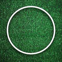 Circular white frame edge on green grass with shadow background photo