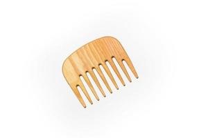 Small wooden comb on a white background photo