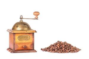 Coffee grinder with mountain of coffee beans photo