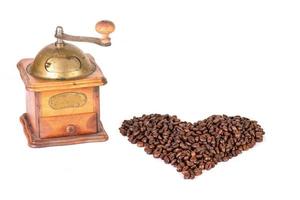 Coffee grinder with coffee beans in the shape of a heart photo