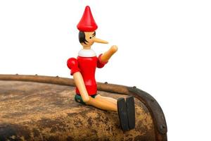 Pinocchio the puppet sitting on a trunk photo