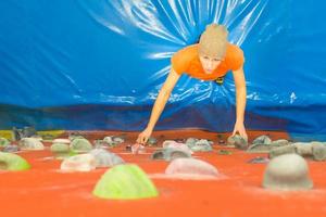 Girl during indoor climbing gym photo