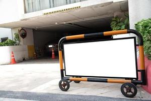 Blank white movable sign in front of car park photo