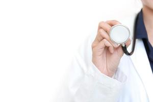 Female Doctor holding stethoscope on white isolated background photo