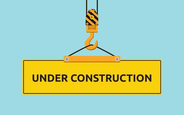 under construction signboard with crane and hook