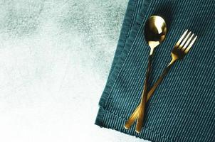 Fork and spoon on table background with space photo