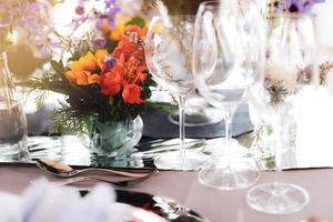 Table setting for a wedding or dinner event, with flowers photo