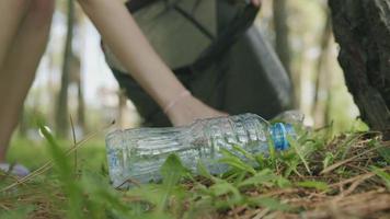 Anonymous woman collecting litter in park video