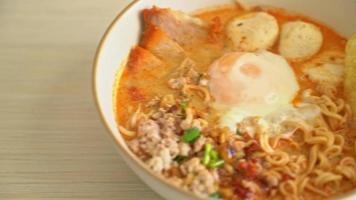 instant noodles with pork and meatballs in spicy Tom Yum soup video