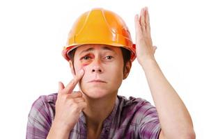 Female worker with a black eye in the helmet photo