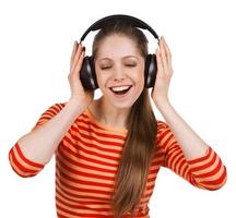 Happy girl listens to music on headphones photo