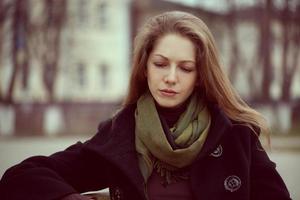 Cute young long-haired woman grieves photo