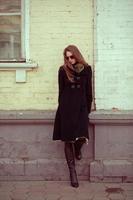 Young woman leaning on a wall photo