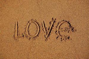 Word love written on the sand photo