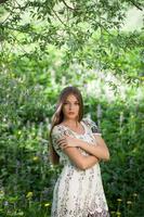 Beautiful girl among the meadow flowers photo