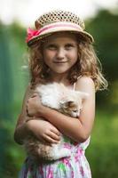 Cute little girl with a kitten photo