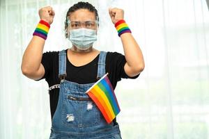 Asian lady holding rainbow color flag, symbol of LGBT photo