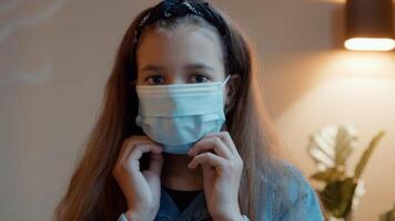 Girl putting on face mask looking into camera lens photo