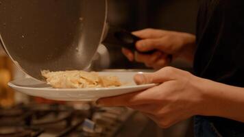 Man handing dish and woman putting fried eggs on it photo