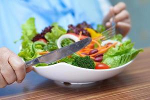 Asian senior woman patient eat breakfast in nursing hospital photo