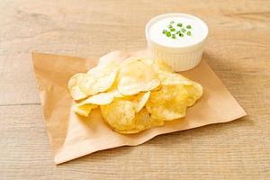 Potato chips with sour cream photo