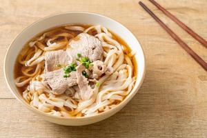 Homemade udon noodles with pork in soy or shoyu soup photo