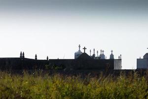 Silhouettes of crosses in a cemetery in Galicia, Spain. photo