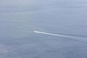 Boat wake in the ocean photo