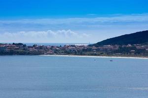 White sand beach and houses in the background photo