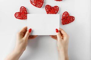 Envelope with a letter in hands on a white background photo