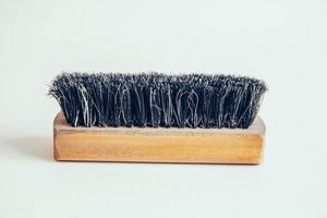 Wooden brush for clothes on a white background photo