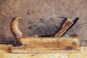 Old woodworking hand tool on a wooden workbench flat lay background photo