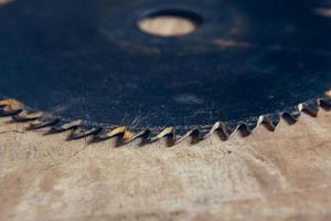 Round blade circular saw on the background of the wooden table photo