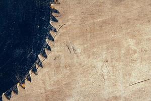 blade circular saw on the background of the wooden table photo