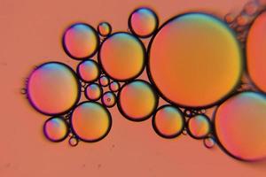 Orange colored oil bubbles in a liquid photo