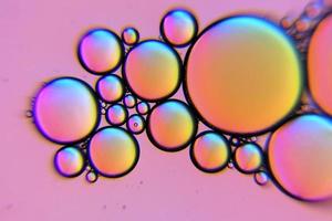 Pink oil bubbles in a liquid photo