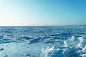Ice blocks on the background of the frozen sea photo