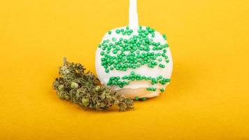 cannabis sweets, candy with thc concentrate on yellow background photo