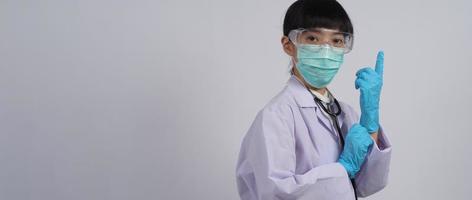 usando guantes. El médico asiático usa guantes de manos de nitrilo de goma azul.