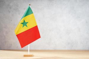 Senegal table flag on white textured wall. Copy space photo