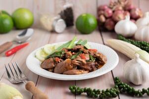 Holy Basil Fried Rice with Chicken Heart on a White Wooden Floor. photo