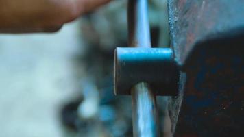 The man rotates handle of blue grip vice. Close up shot. video